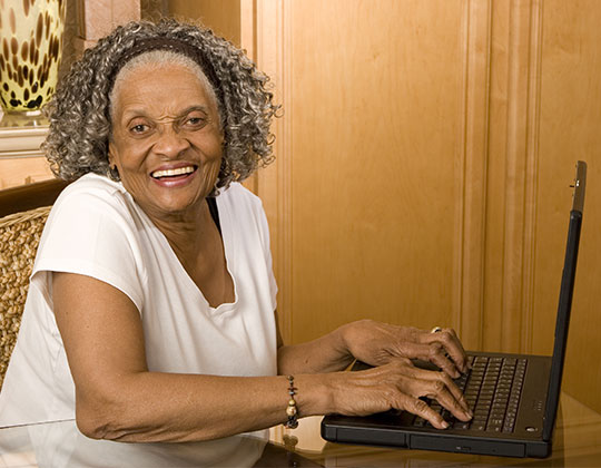 Good Shepherd Woman On Computer - Good Shepherd Fairview Home